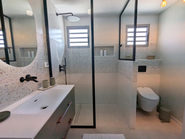 Salle de bain secondaire avec douche et décoration moderne à la villa Nateina Home au Gosier